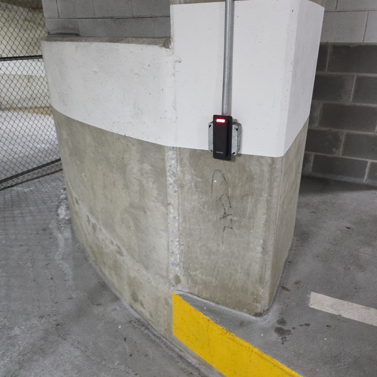 Card reader on a parking garage column with conduit run above